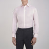 View 2 of product The Turnbull & Asser Pink Herringbone Superfine Cotton Shirt features a T&A collar, double cuffs, and clean-cut design, displayed neatly folded against a white background.
