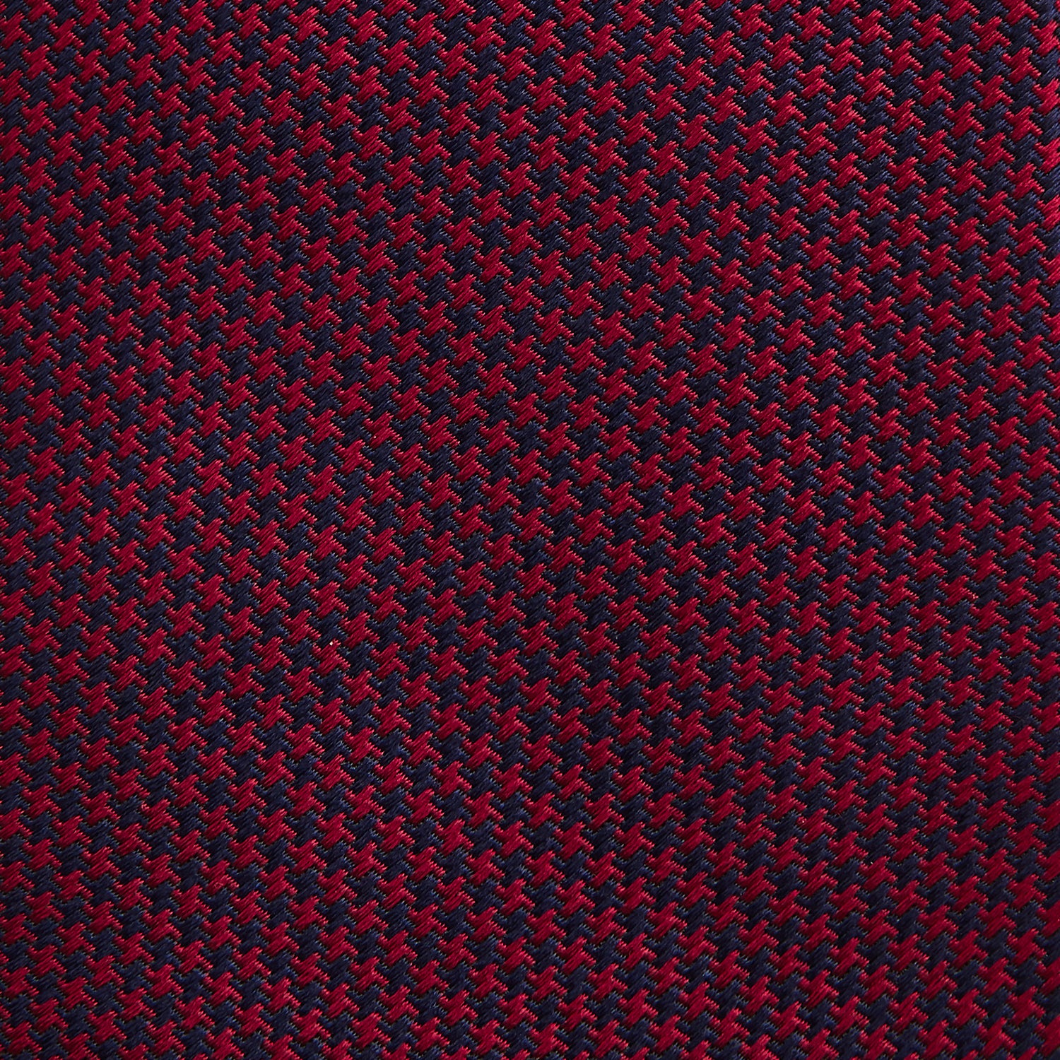 View 3 of product The HOUNDSTOOTH NAVY BURGUNDY TIE by Turnbull & Asser features a textured navy and burgundy silk woven pattern—an elegant staple for every gentleman’s wardrobe.