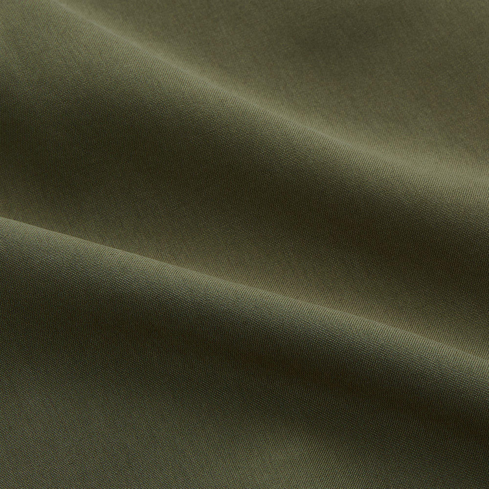 The Turnbull & Asser Green Silk Regular Fit Flaxton Shirt features long sleeves, a classic Bury collar, white buttons, and a straight hem, shown against a plain white background.