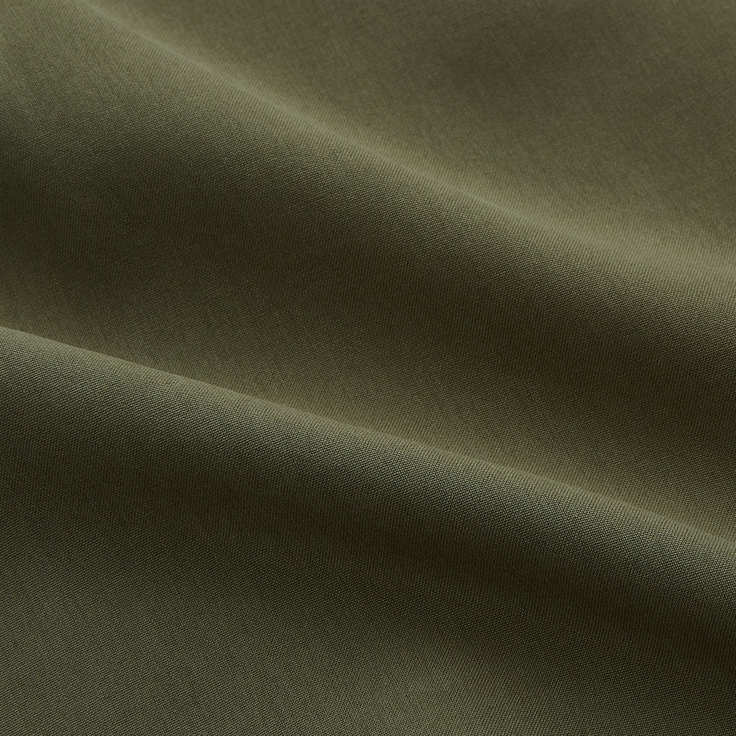 View 4 of product The Turnbull & Asser Green Silk Regular Fit Flaxton Shirt features long sleeves, a classic Bury collar, white buttons, and a straight hem, shown against a plain white background.