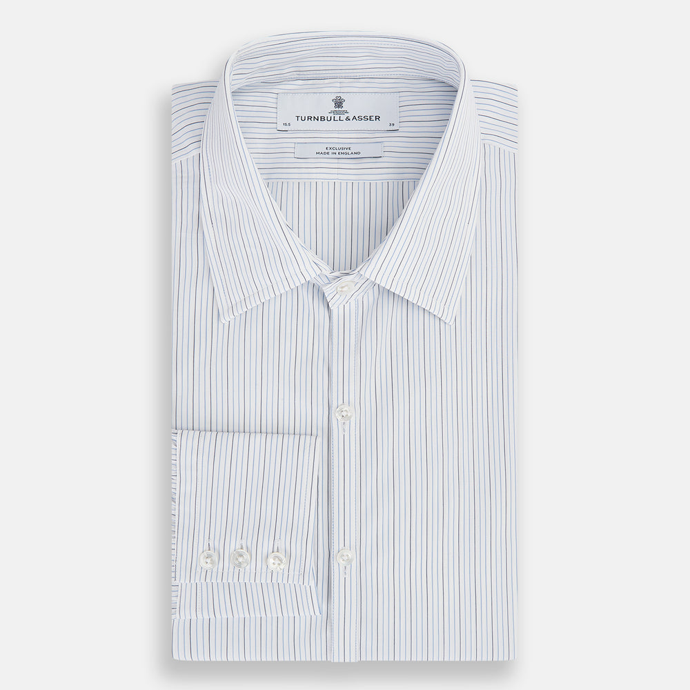 The Turnbull & Asser Pale Blue and Navy Pinstripe Westminster Shirt features long sleeves, a classic collar, and buttoned cuffs, highlighting British craftsmanship. The shirt is laid flat on a white background.