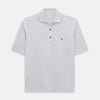 View 1 of product A soft pink cotton polo shirt by Turnbull & Asser features short sleeves, a contrasting white collar, three dark buttons, and a left chest pocket. Laid flat on a white background—it’s perfect for modern men’s fashion.