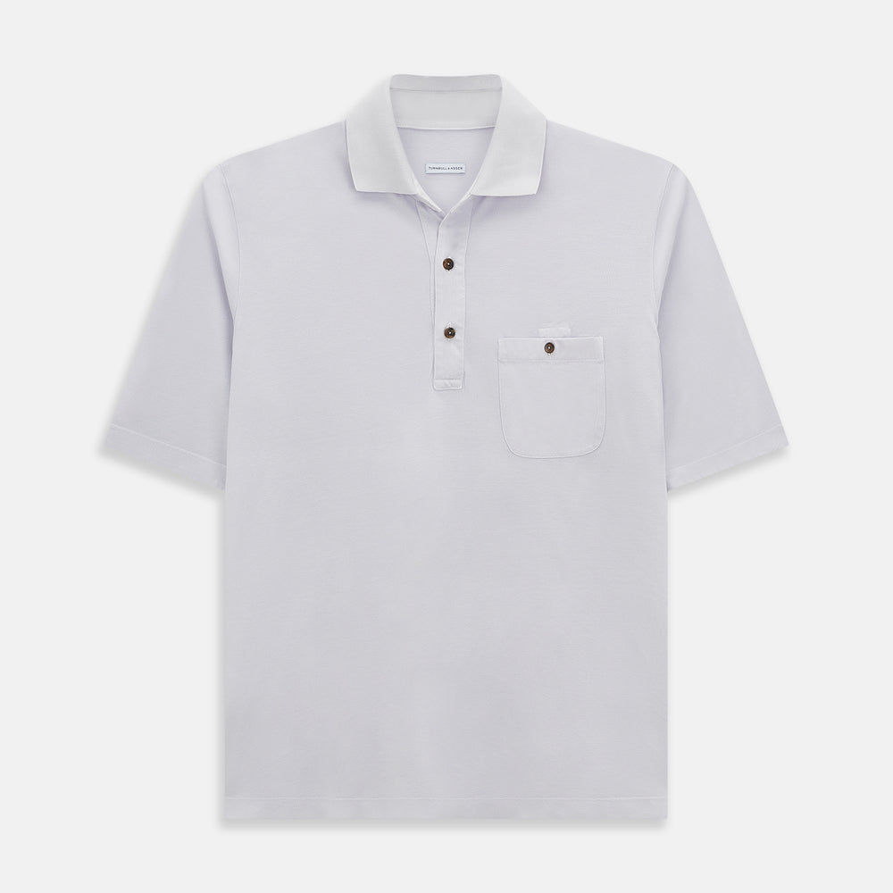 A soft pink cotton polo shirt by Turnbull & Asser features short sleeves, a contrasting white collar, three dark buttons, and a left chest pocket. Laid flat on a white background—it’s perfect for modern men’s fashion.