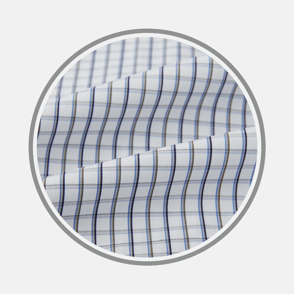 Close-up of Turnbull & Asser Blue And Coffee Tattersall Fabric, featuring a white base with blue and beige plaid checks, shown within a circular frame. The fabric has a smooth texture and subtle folds.
