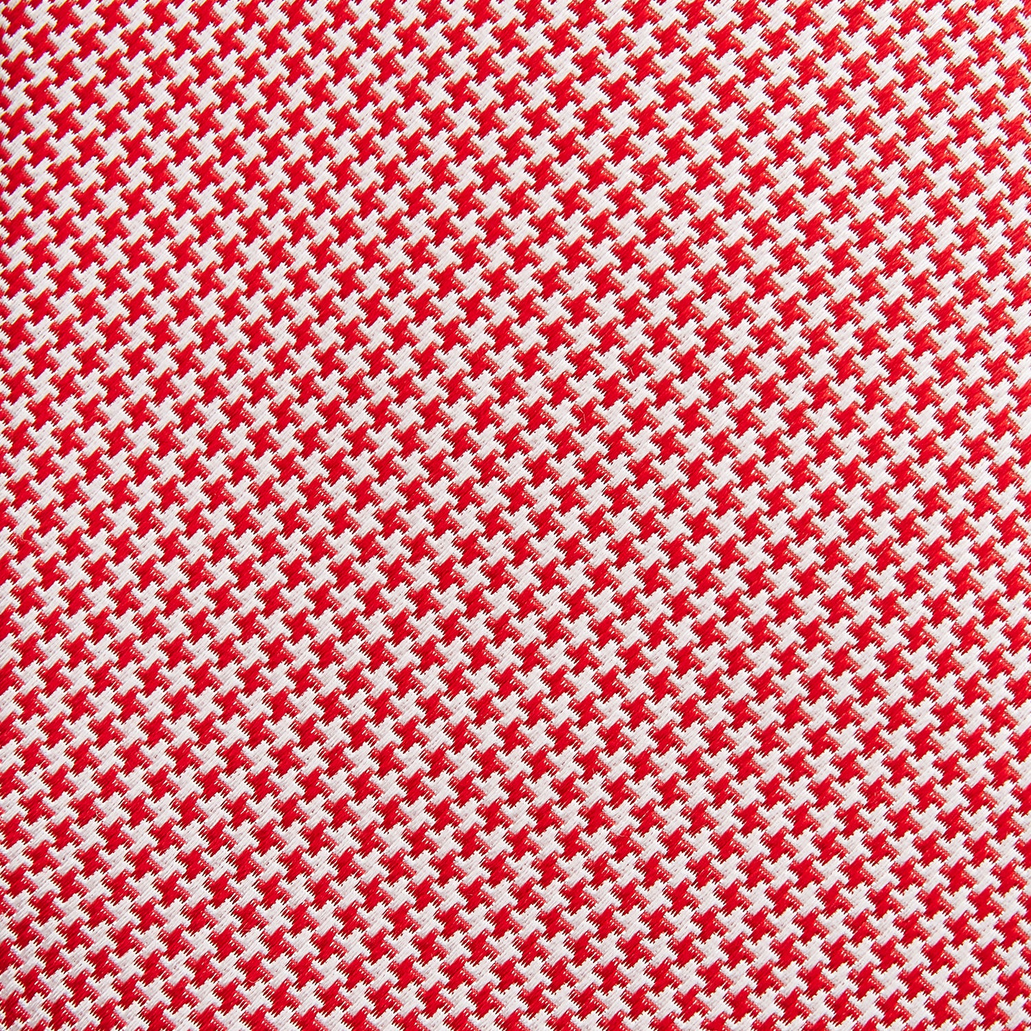 View 3 of product The Turnbull & Asser Red and White patterned silk tie, crafted from fine silk with a small geometric design, is elegantly rolled and displayed on a white background—a refined men’s accessory.