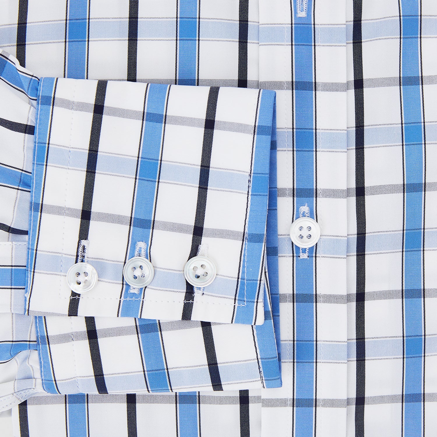 View 4 of product The Turnbull & Asser Blue and Navy Combination Check Mayfair Shirt features a classic button-up style with long sleeves, T&A collar, and a blue, navy, and white check pattern, shown against a plain white background.