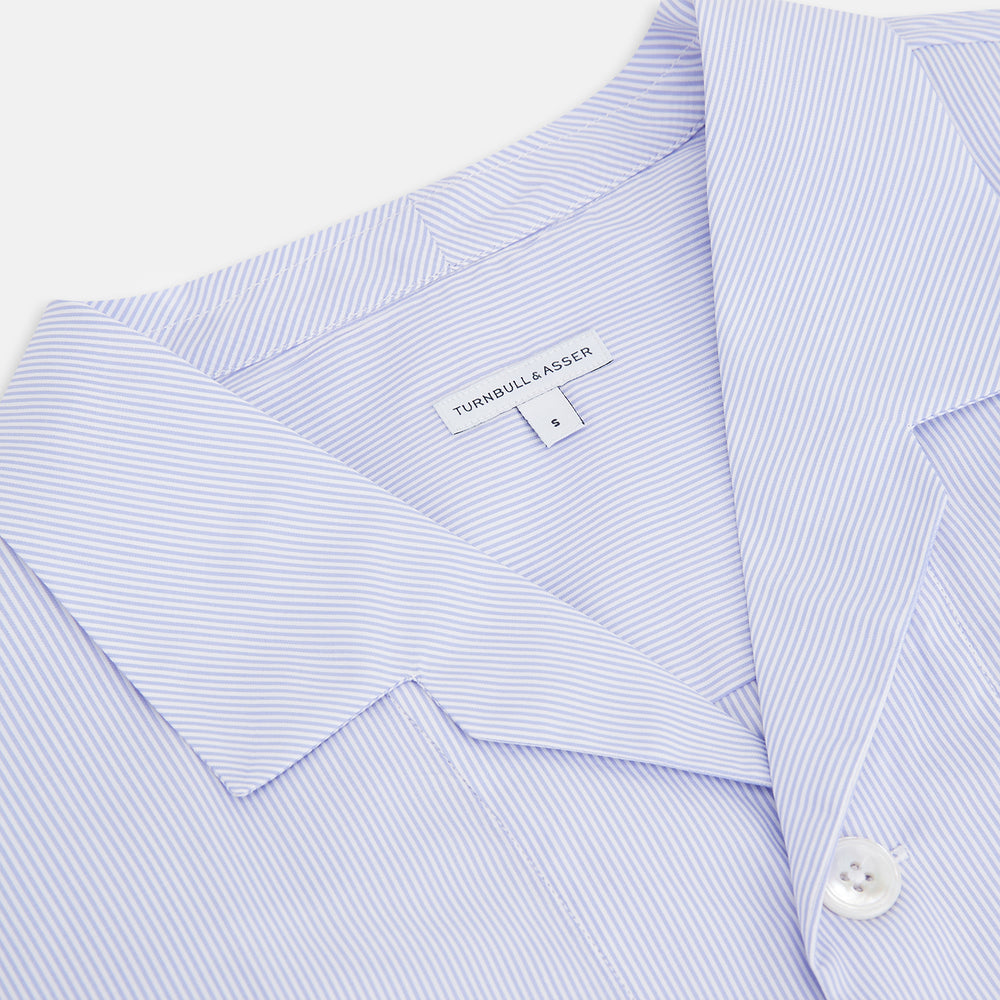 The Turnbull & Asser Pale Blue Hairline Stripe Pyjama Shirt features long sleeves and a single chest pocket, offering an elegant sleepwear style—shown on a plain white background.