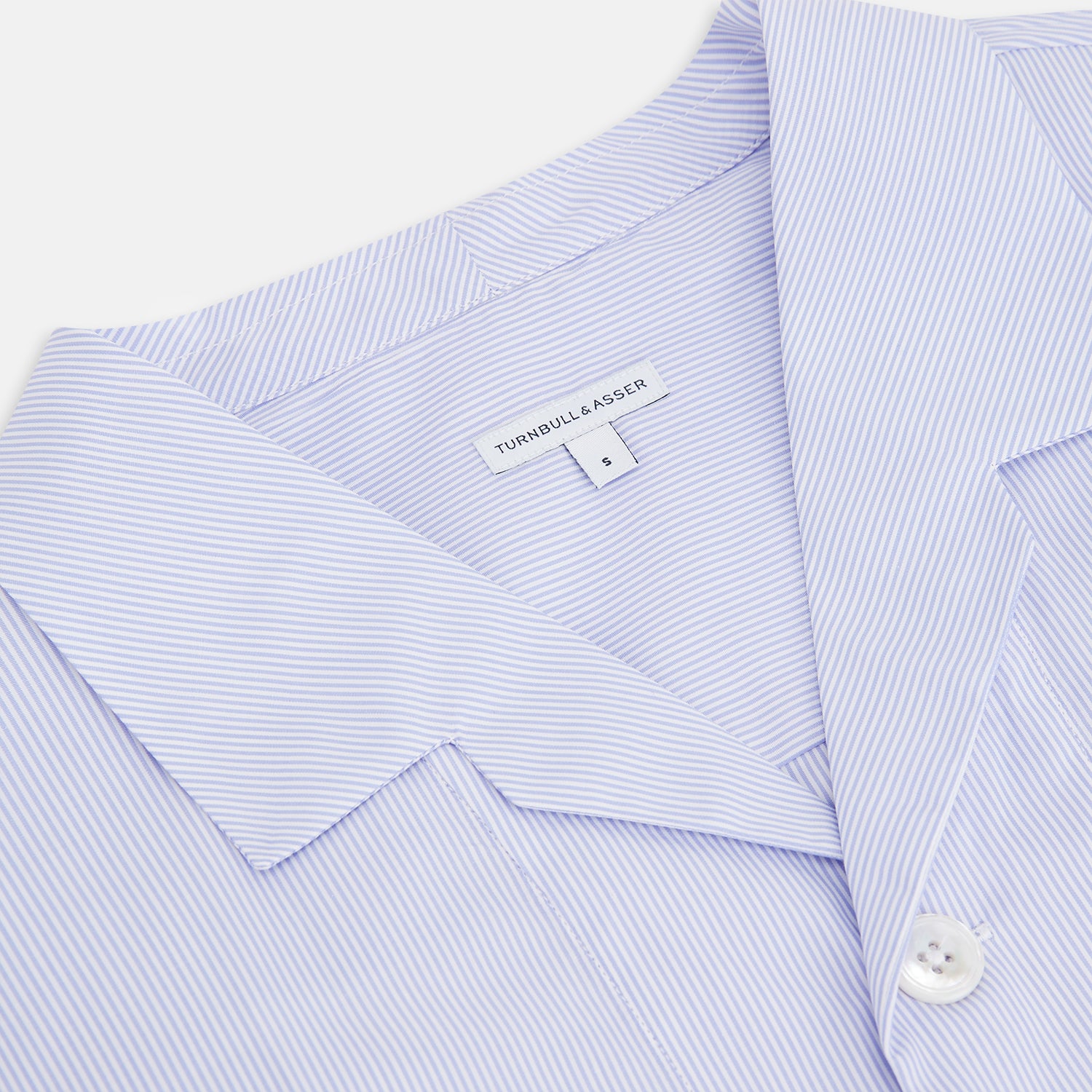 View 2 of product The Turnbull & Asser Pale Blue Hairline Stripe Pyjama Shirt features long sleeves and a single chest pocket, offering an elegant sleepwear style—shown on a plain white background.