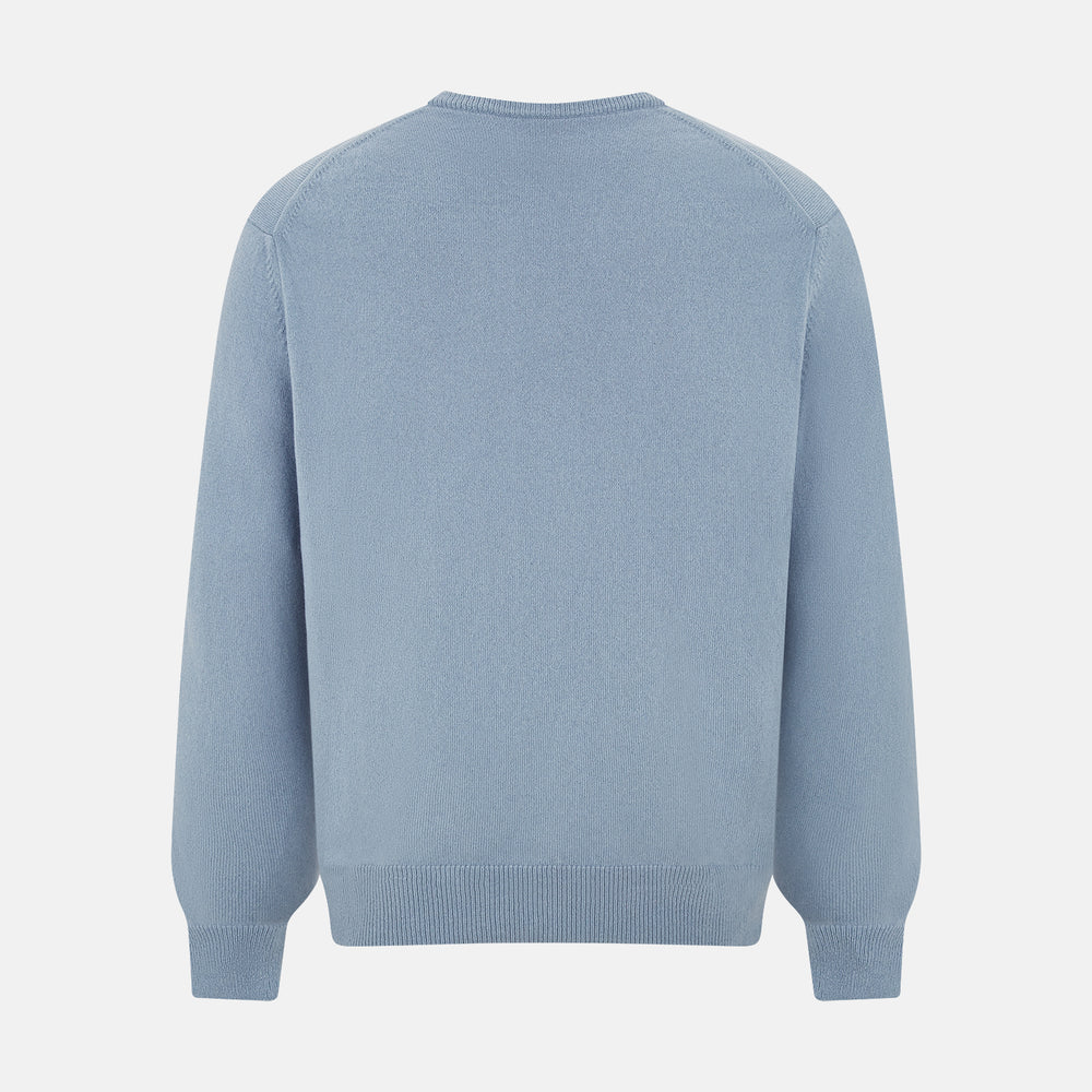 The Turnbull & Asser Frost Blue Cashmere V-Neck Jumper features ribbed cuffs, hem, and neckline. This elegant long sleeve knitwear piece is shown on a plain white background.