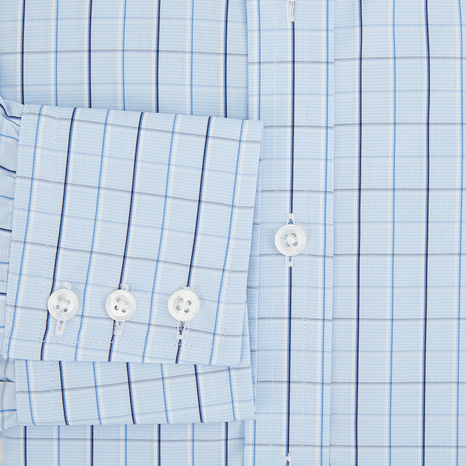 View 4 of product The Navy and Blue Combination Check Mayfair Shirt by Turnbull & Asser features a light blue base with a grid of thin dark blue lines, long sleeves, a pointed collar, and is neatly displayed on a plain white background.