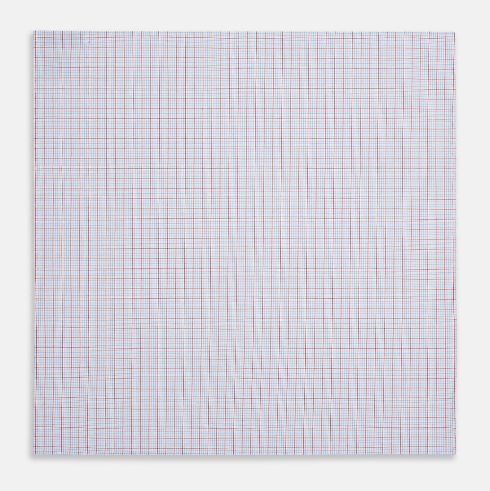 The Turnbull & Asser Hand Rolled Red Multi Graph Check Handkerchief features blue and red grid lines on white, with a red check forming larger squares and blue lines creating smaller squares within the design.