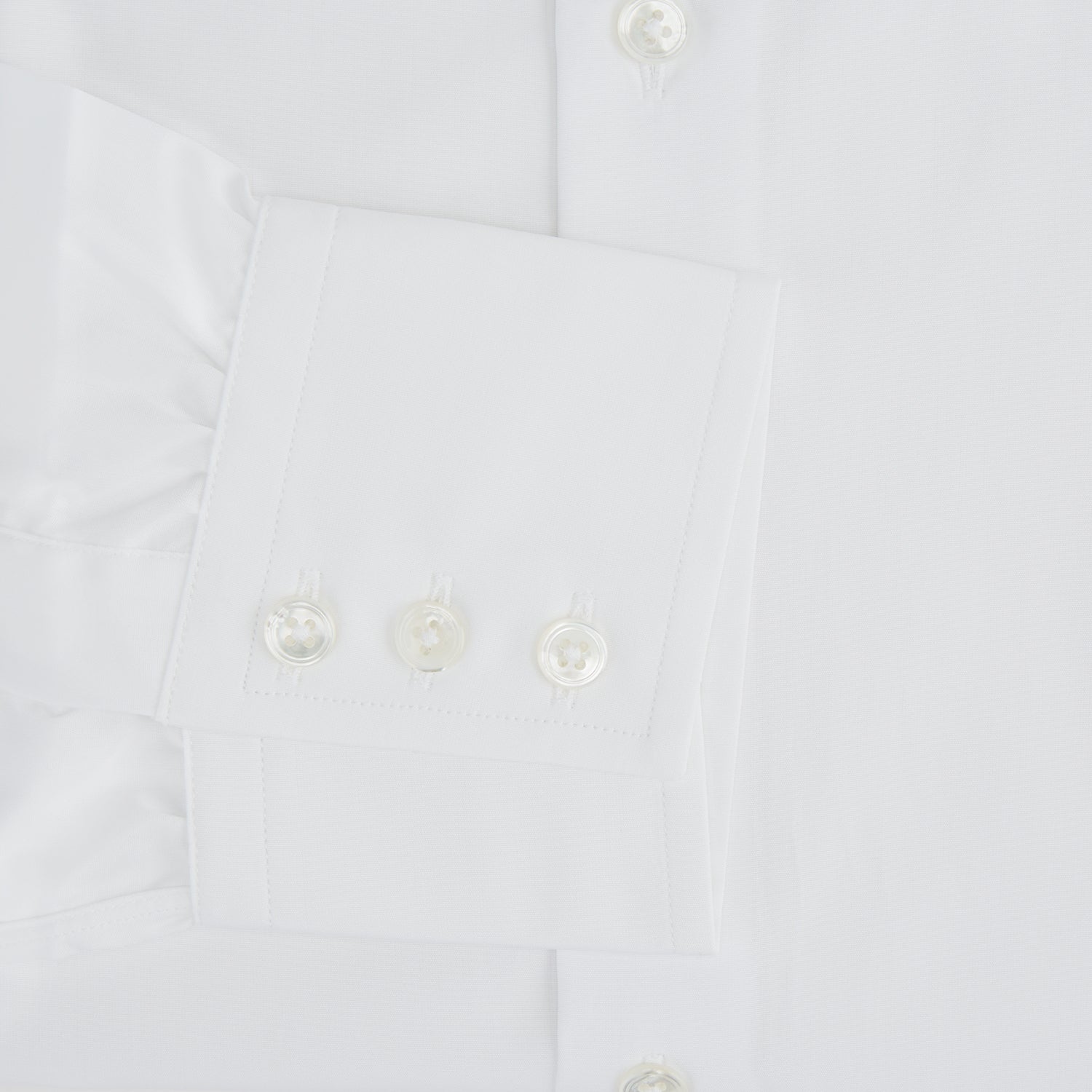 View 3 of product The Turnbull & Asser Tailored Fit Plain White Cotton Shirt features a classic kent collar and 3-button cuffs, displayed against a white background.