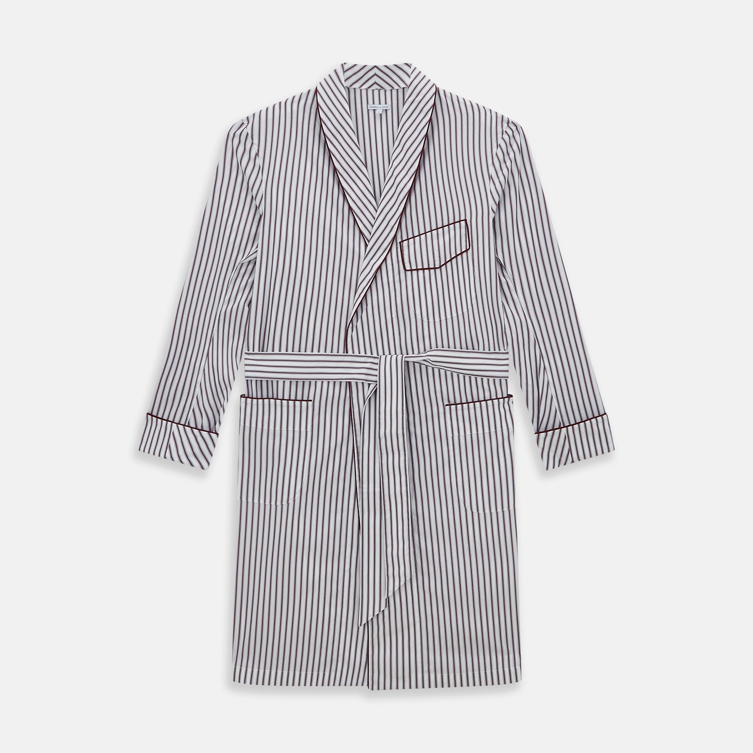 View 1 of product The Burgundy Multi Stripe Winston Gown by Turnbull & Asser features long sleeves, a shawl collar, waist belt, three pockets, and red piping accents for a classic Churchill-inspired touch.