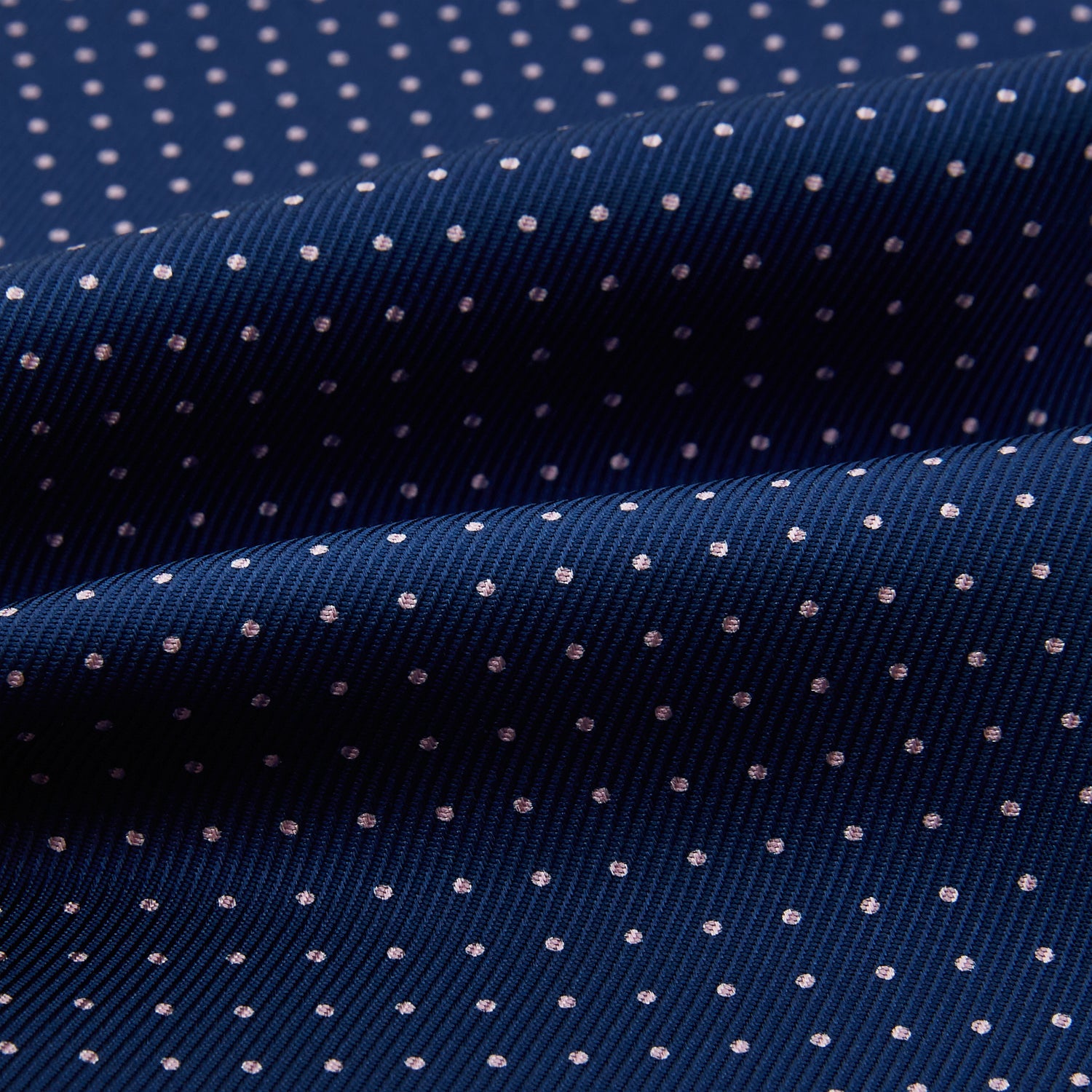 View 4 of product The Turnbull & Asser Pink Dot and Royal Blue Silk Cravat is an elegant British-style wedding accessory, neatly folded with a pointed edge and finished with pink dots, perfect for complementing formal attire.