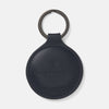 View 1 of product The Dark Navy Leather Fob Holder by Turnbull & Asser features round, dark blue leather with subtle embossed branding and a metallic key ring.