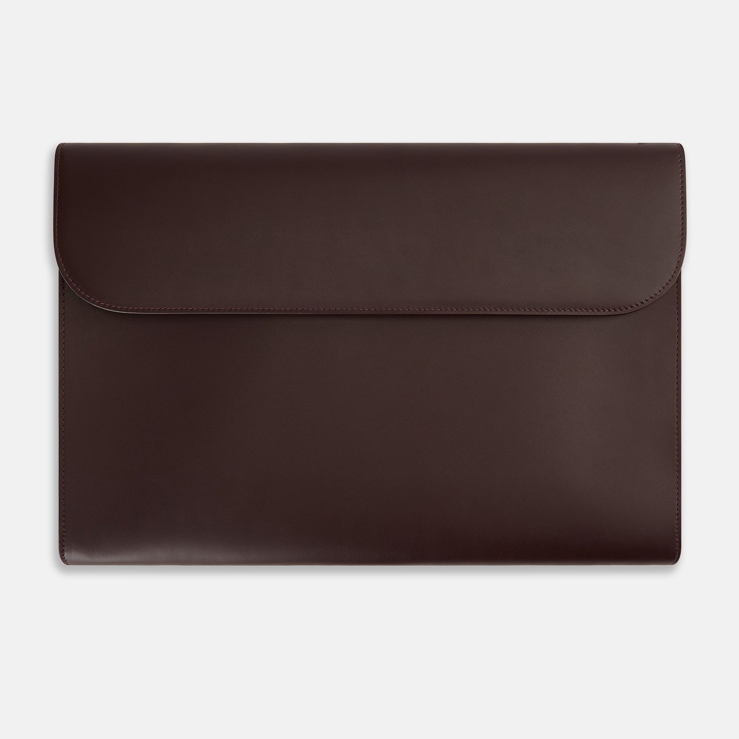 View 1 of product The Turnbull & Asser Burgundy Leather Snap-Fasten Pouch is a sleek, envelope-style laptop accessory with a smooth finish, curved flap, and elegant snap closure, ideal for business travel against a white background.