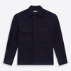 View 1 of product The Turnbull & Asser Navy Greenwich Knitted Overshirt, made from Italian wool with a collar, two front flap pockets, and a hidden button placket, is shown laid flat on a white background.