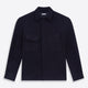 The Turnbull & Asser Navy Greenwich Knitted Overshirt, made from Italian wool with a collar, two front flap pockets, and a hidden button placket, is shown laid flat on a white background.