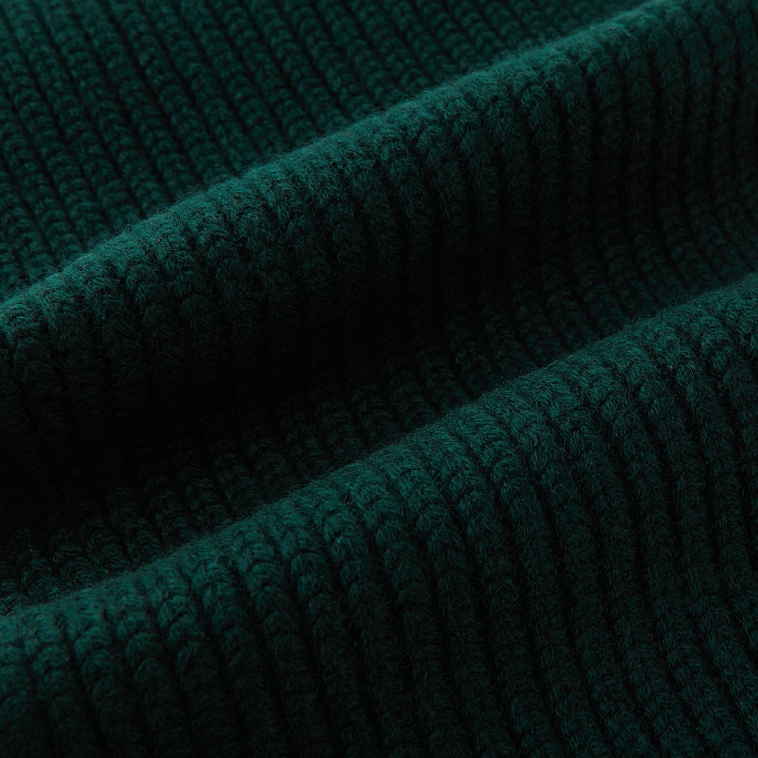 View 3 of product The Turnbull & Asser Forest Green Rib-Knit Cashmere Scarf is shown neatly looped and ribbed, set against a plain white background.