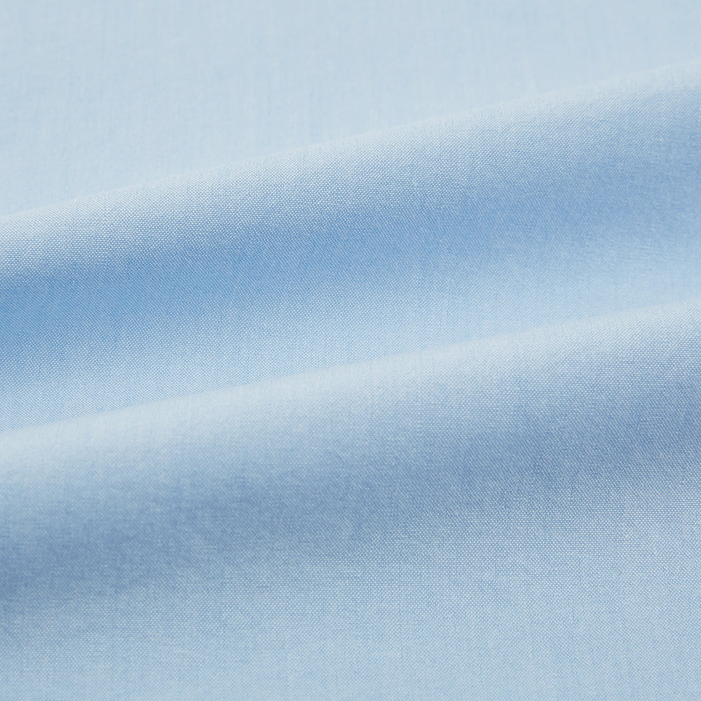 The Blue Hyde Overshirt by Turnbull & Asser features a light blue hue, long sleeves, a button-up front, and a single chest pocket. Crafted from sanforised cotton and shown laid flat on a white background.