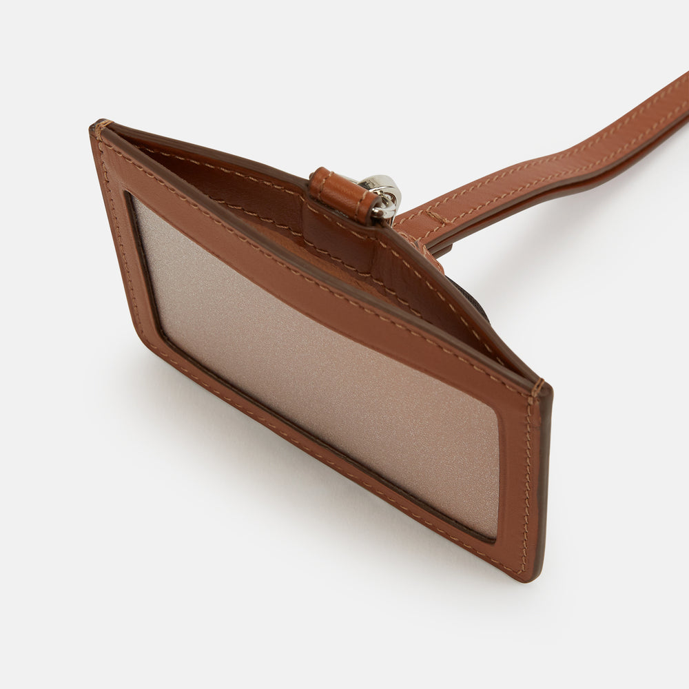 The Turnbull & Asser Camel ID Card Holder, shown on a white background, features Italian leather in brown with a matching lanyard, silver clasp, keychain tag, and "Turnbull & Asser" embossed in gold lettering.