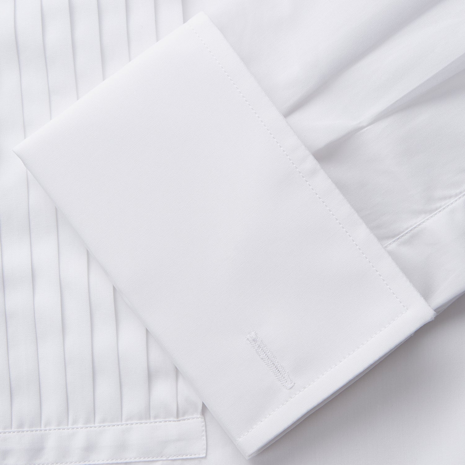 View 4 of product The Turnbull & Asser White Pleated Cotton Dress Shirt features a T&A collar and double cuffs, shown laid flat on a white background.