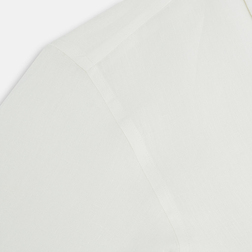 The Vanilla Linen Westminster Shirt by Turnbull & Asser is a long-sleeve, white button-up with a Turnbull collar, buttoned cuffs, and straight hem, highlighting British craftsmanship against a plain white background.