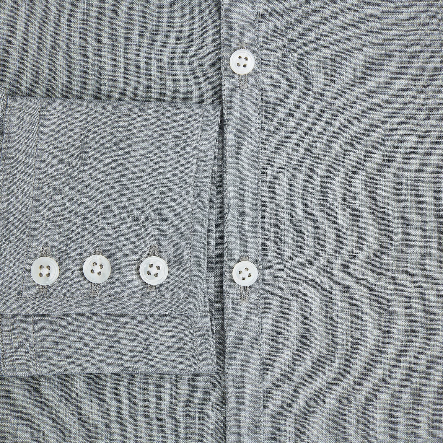 View 4 of product The Grey Linen Westminster Shirt by Turnbull & Asser is a long-sleeve, light gray button-up with a formal collar and white buttons, highlighting British craftsmanship and laid flat on a white background.