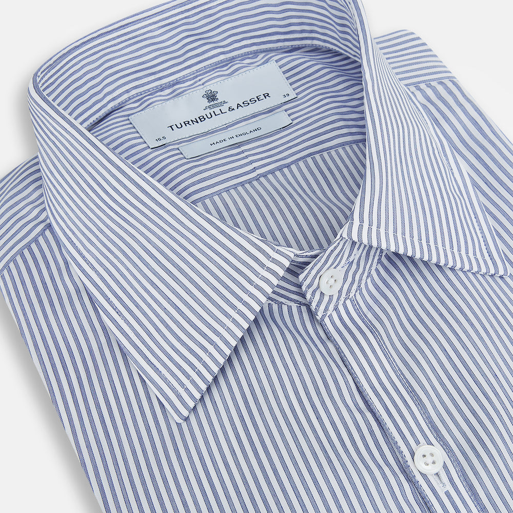 The Turnbull & Asser Navy and White Stripe Westminster Shirt features thin vertical stripes, a Turnbull collar, long sleeves, and classic British craftsmanship, shown flat on a white background.
