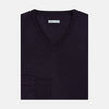 View 4 of product The Turnbull & Asser Dark Purple Fine Merino V-Neck Jumper features long sleeves and a classic knit, shown against a white background.