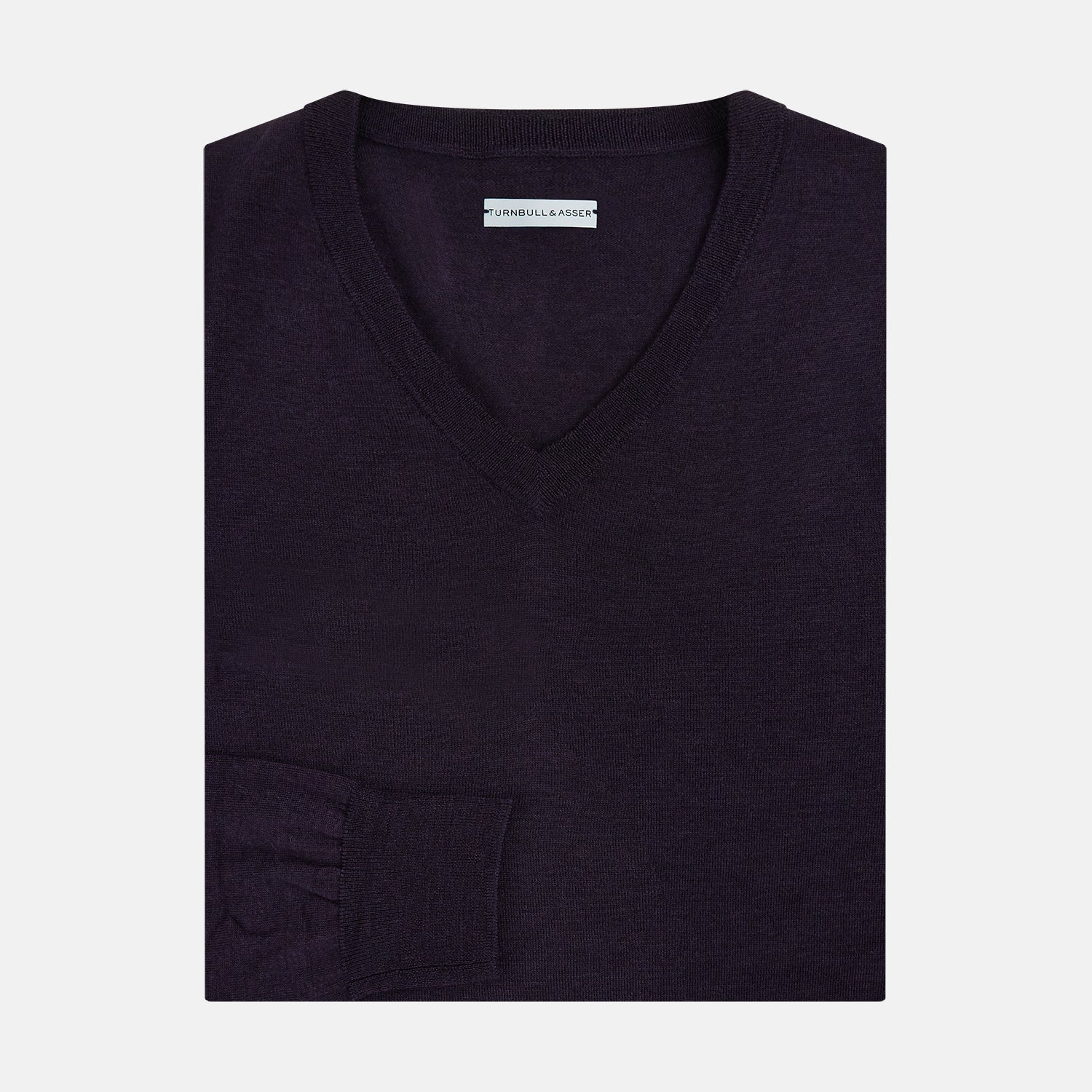 View 4 of product The Turnbull & Asser Dark Purple Fine Merino V-Neck Jumper features long sleeves and a classic knit, shown against a white background.