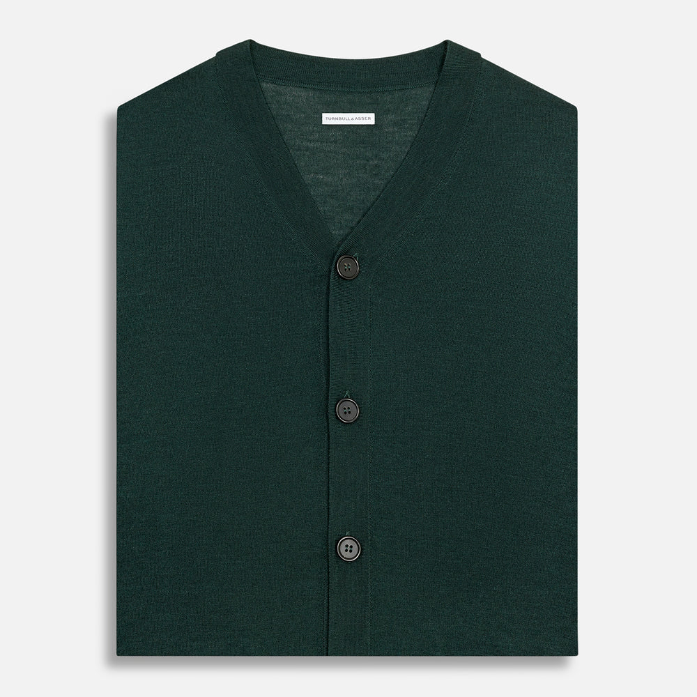 The Turnbull & Asser Petrol Green Fine Merino V-Neck Sleeveless Cardigan features two front pockets, a button-up design, and is shown against a plain white background.