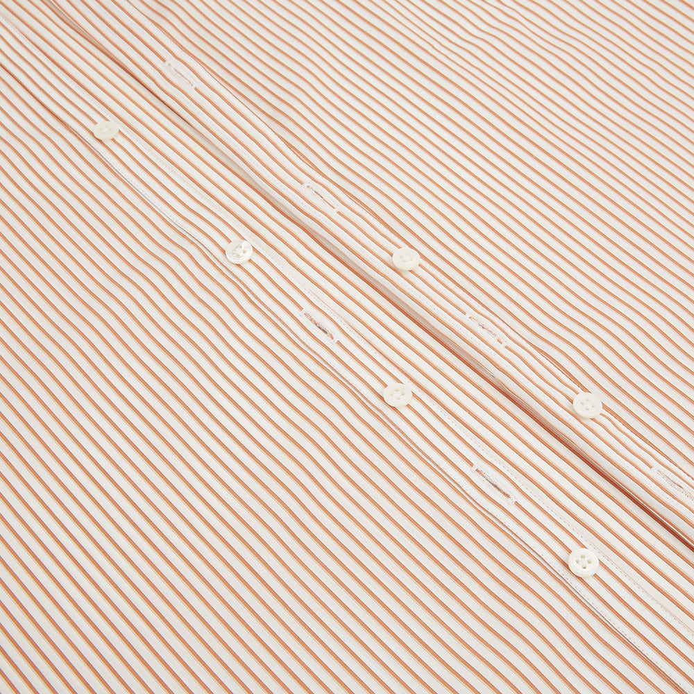 The Orange Multi Stripe Westminster Shirt by Turnbull & Asser features thin vertical orange and white stripes, a Turnbull collar, and long sleeves, elegantly displayed flat against a white background.