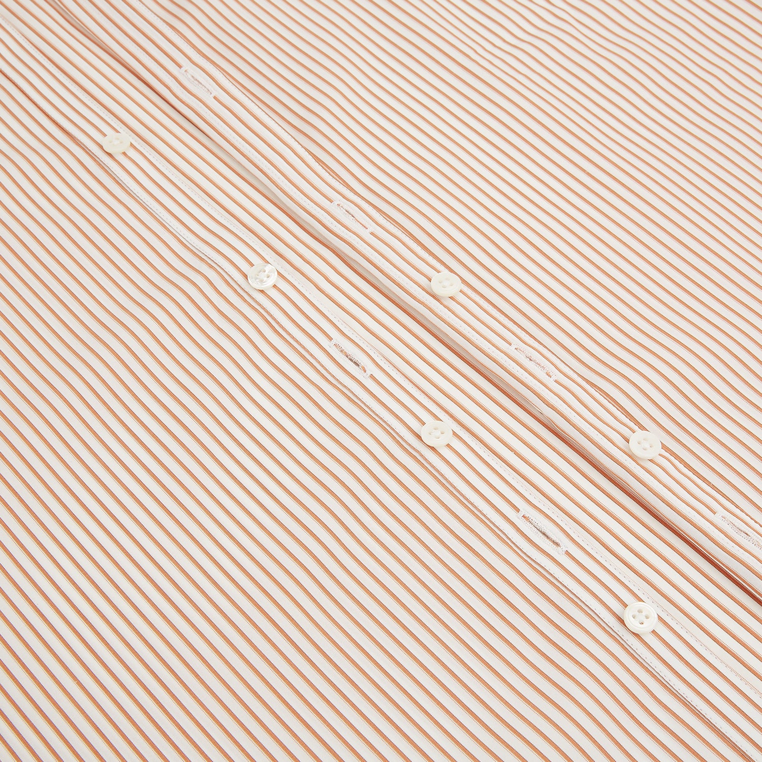 View 7 of product The Orange Multi Stripe Westminster Shirt by Turnbull & Asser features thin vertical orange and white stripes, a Turnbull collar, and long sleeves, elegantly displayed flat against a white background.