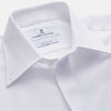 View 2 of product The Turnbull & Asser WHITE TAILORED FIT DRESS SHIRT features a pointed collar, buttoned cuffs, and a concealed button placket, shown on a plain white background.