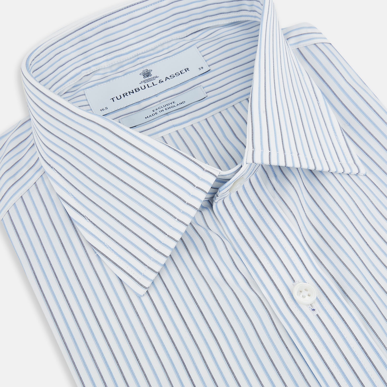 View 2 of product The Turnbull & Asser Navy and Blue Shadow Stripe Mayfair Shirt, featuring a classic T&A collar and buttoned cuffs, is laid flat on a white background.