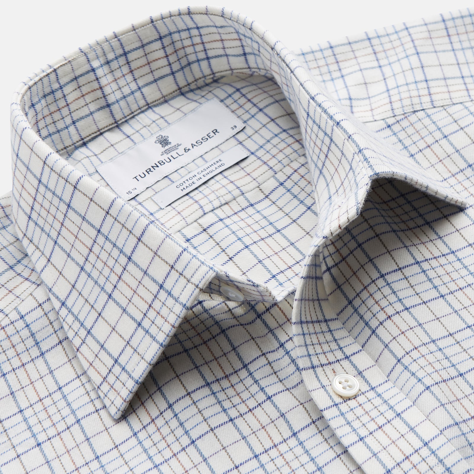 View 2 of product The Turnbull & Asser Blue Multi Check Regular Fit Cotton-Cashmere Shirt features a T&A collar, 3 button cuffs, and a white background with tonal blue and light brown checks—shown flat against a white background.
