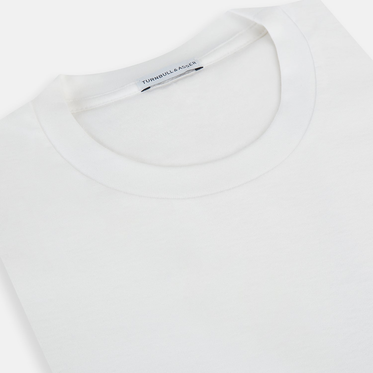 View 2 of product The Turnbull & Asser White Long-Sleeve T-shirt for men is a plain crew neck design with no logos or patterns, displayed flat on a white background.