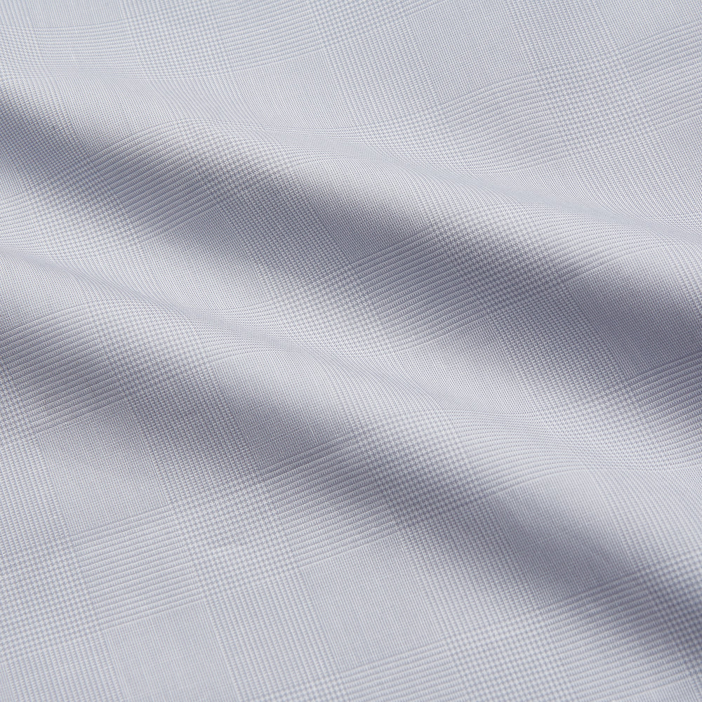 The Turnbull & Asser Faded Blue Block Check Cotton Regular Fit Mayfair Shirt, featuring long sleeves, a classic collar, and white buttons, is neatly laid flat on a white background.