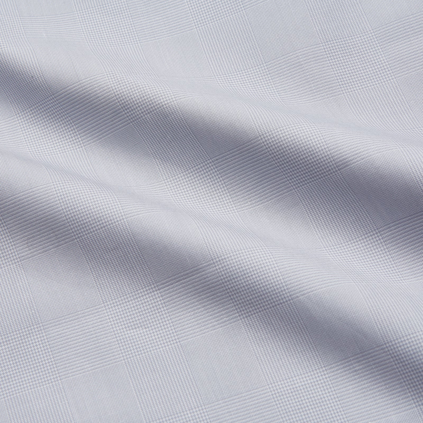 View 4 of product The Turnbull & Asser Faded Blue Block Check Cotton Regular Fit Mayfair Shirt, featuring long sleeves, a classic collar, and white buttons, is neatly laid flat on a white background.