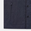 View 7 of product The Turnbull & Asser Navy Hampstead Overshirt features a collar, left chest pocket, two zippered pockets near the bottom, and a classic long-sleeve button-up design, shown laid flat on a white background.