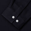 View 3 of product A Navy Cotton Holiday Fit Winnington Shirt by Turnbull & Asser, featuring long sleeves, a chest pocket, white buttons, and a revere collar, is laid flat on a white background.