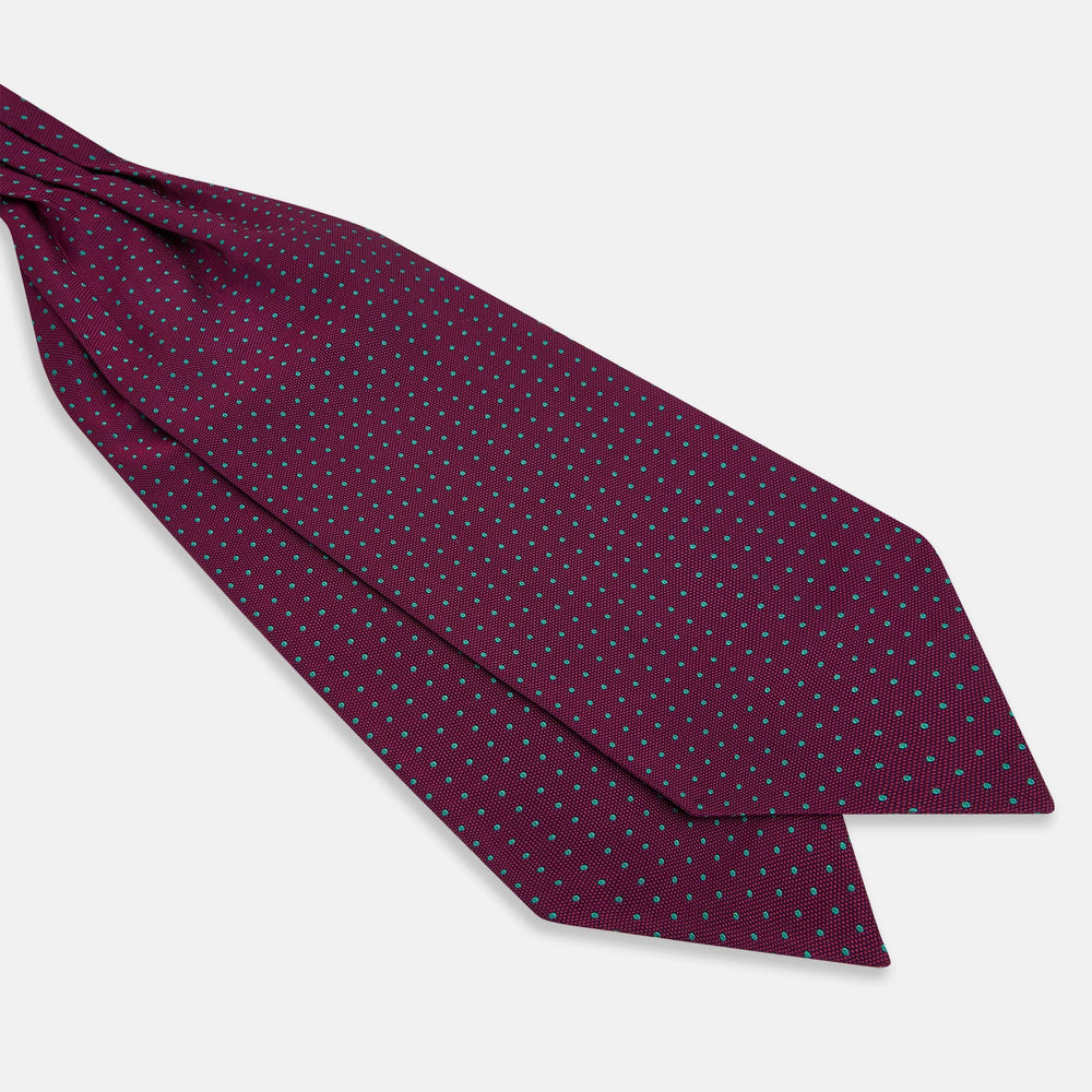 A burgundy pocket square with turquoise polka dots, folded to a point—an ideal men's formal accessory to complement the Green Micro Dot and Magenta Silk Cravat by Turnbull & Asser.