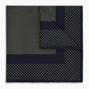 View 1 of product The Turnbull & Asser Navy and Gold Silk Pocket Square is handmade, featuring small gold polka dots on navy with a solid border, displayed neatly folded with one corner turned up.