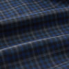 View 3 of product The Turnbull & Asser Blue Multi Check Wool Quin Pyjama Set features a long-sleeve button-up top with chest pocket and drawstring pants, both displayed flat on white—a luxurious choice for refined sleepwear.