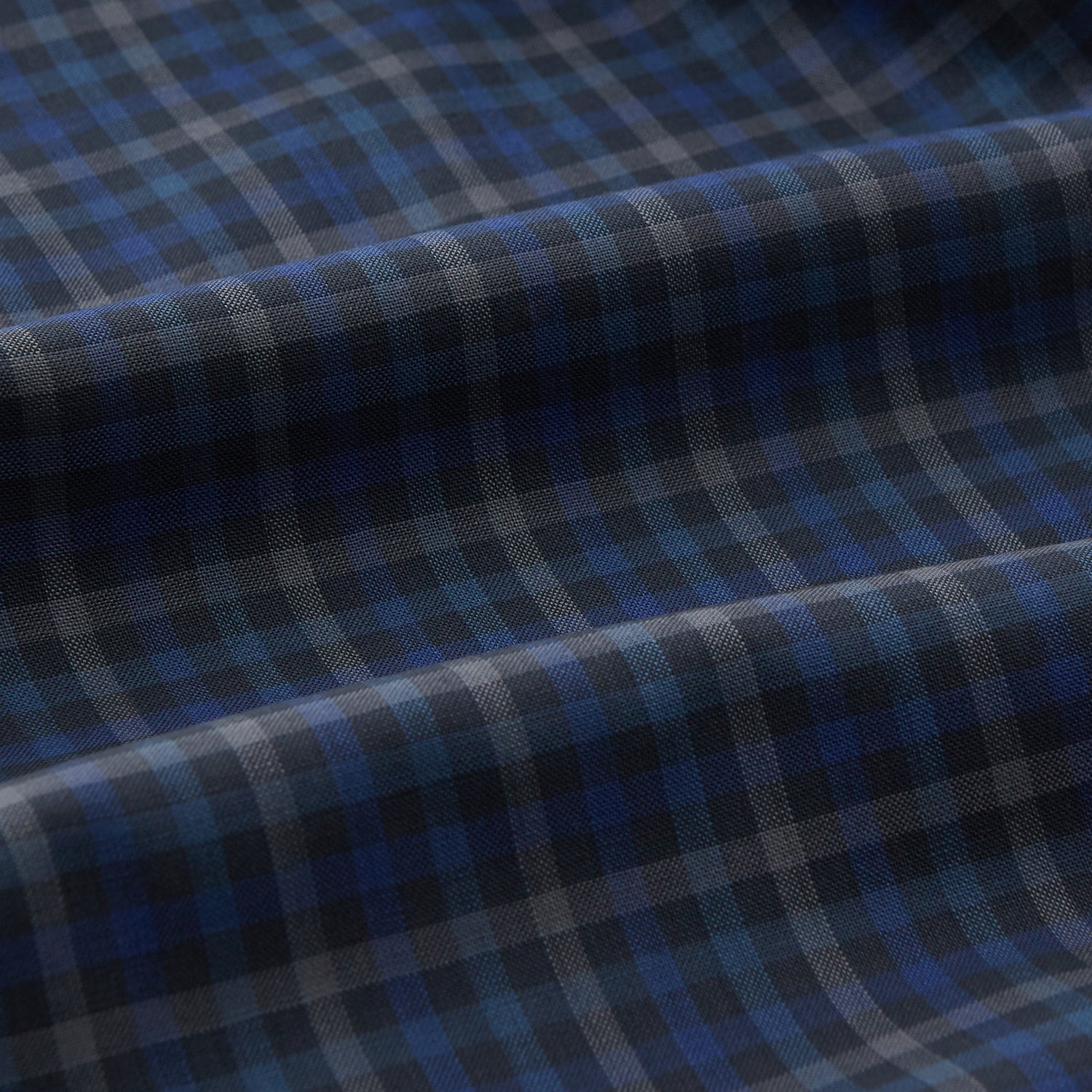View 3 of product The Turnbull & Asser Blue Multi Check Wool Quin Pyjama Set features a long-sleeve button-up top with chest pocket and drawstring pants, both displayed flat on white—a luxurious choice for refined sleepwear.