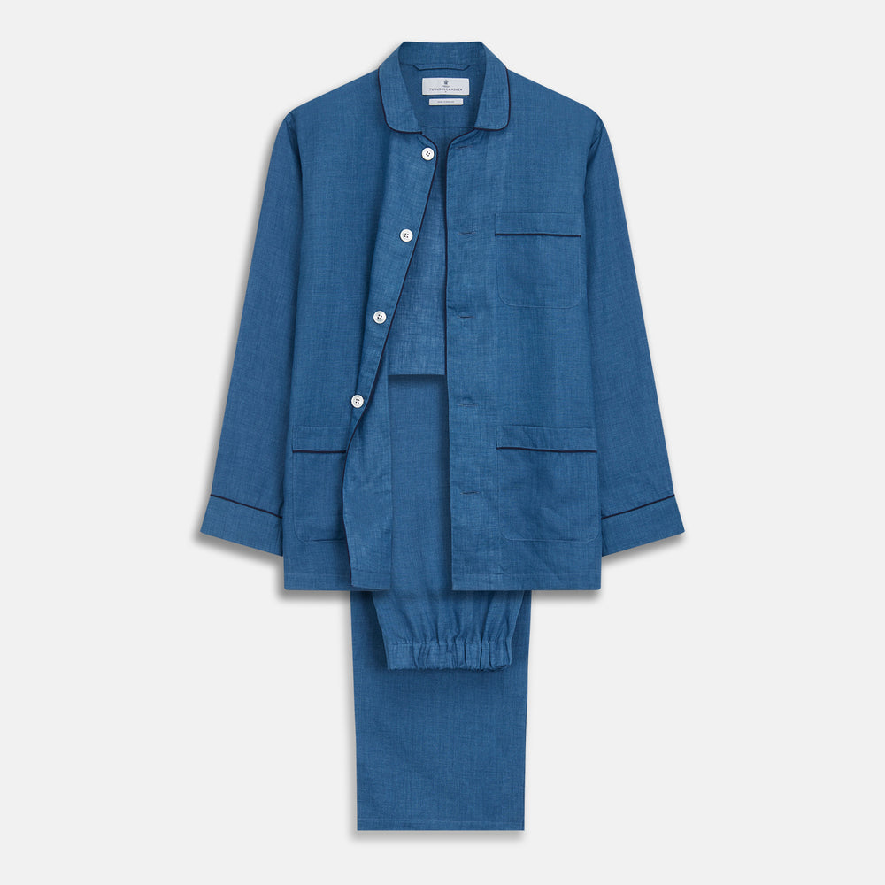 A person stands barefoot against a plain background, wearing the Teal Linen Modern Pyjama Set from Turnbull & Asser.