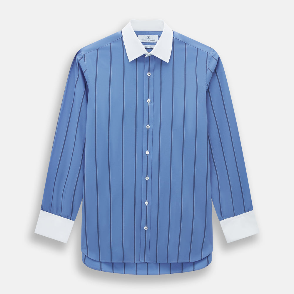 The Turnbull & Asser Colony Blue Track Stripe Shirt features vertical dark blue stripes, a Mayfair fit, and contrast white T&A collar and cuffs, reflecting British craftsmanship against a plain light background.