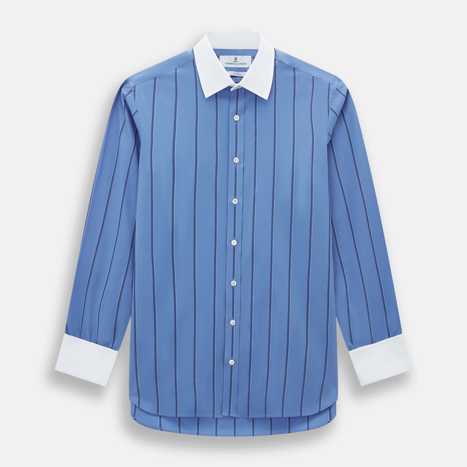 View 1 of product The Turnbull & Asser Colony Blue Track Stripe Shirt features vertical dark blue stripes, a Mayfair fit, and contrast white T&A collar and cuffs, reflecting British craftsmanship against a plain light background.