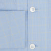 View 4 of product The Turnbull & Asser Blue Prince of Wales Check Pyjama Shirt features long sleeves, a notched collar, a left chest pocket, and a subtle check pattern, shown laid flat on a white background.